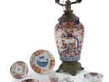 a vase with a lamp on top of it next to other items