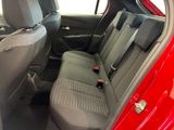 the back seats of a red car are clean and ready to be used