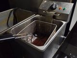 a deep fryer with a basket of food inside of it