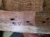 a close up of a piece of wood with holes in it