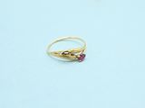 an image of a gold ring with a ruby stone