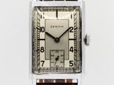 an image of a silver square watch with a brown leather strap