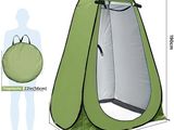 a close up of a green tent with a person standing next to it