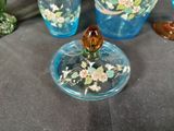 three glass vases with flowers on them on a table