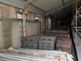 a large warehouse with a lot of wooden pallets on the floor