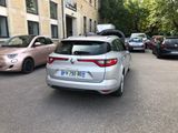 a silver car parked on the side of the street