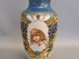 a blue vase with a picture of a woman on it