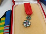 a small box with a medal and a ribbon on it