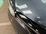 a close up of a car ' s hood with a broken window