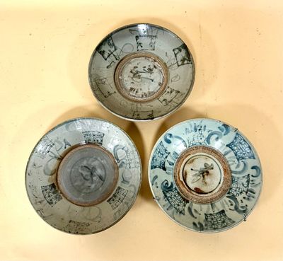 three bowls with designs on them are sitting on a table