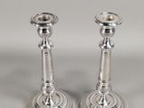 pair of silver plated candlesticks on a white background