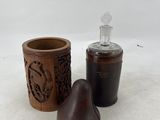 a bottle and a cup sitting next to each other on a white surface
