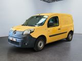 yellow van parked in a white room with a black floor