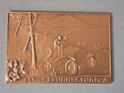 une plaque métallique sur laquelle figure la photo d'un homme au volant d'une voiture