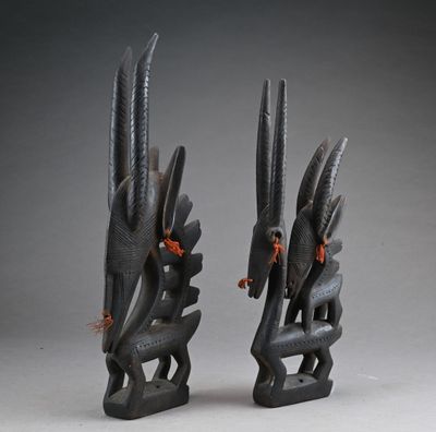 pair of african carved wooden sculptures of a bird and a snake