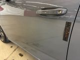 a close up of a car door handle with a sticker on it