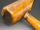 wooden mallet on a gray background