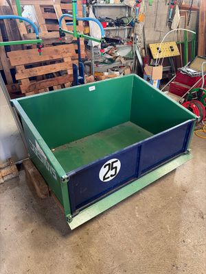 a green box with a number on it in a garage