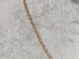 a close up of a gold necklace on a mannequin mannequin mannequin mannequin mannequin mannequin mannequin manne