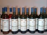 several bottles of wine are lined up on a table