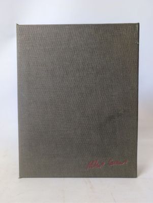 a brown book with red writing on it sitting on a white surface