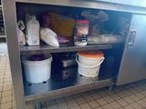 a metal cabinet with buckets and containers on it