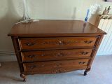 une commode en bois dans un coin d'une chambre