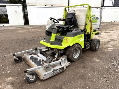 a lawn mower that is sitting in the dirt