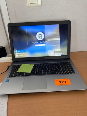 a laptop computer sitting on a desk with a price tag on it