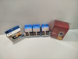 three boxes of different colored ink sitting next to each other on a white surface