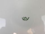 a white plate with a green and black design on it