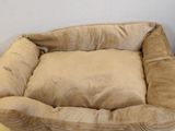 a dog bed on the floor in the corner of a room