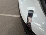 a sticker on the hood of a car that has a clock on it