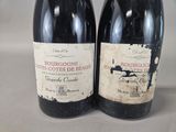 two bottles of wine sitting next to each other on a table