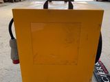 a yellow box that is sitting on the ground