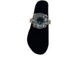 an image of a ring with a blue topaz stone on a black ring stand