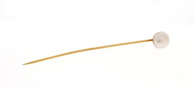 a stick with a button on it on a white surface