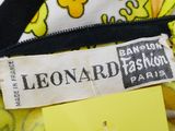 the label of a yellow and black dress with yellow flowers on it