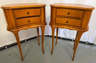 pair of wooden nightstand tables with drawers on each side of them