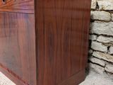 a close up of a wooden chest on a stone wall