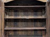 an old wooden cabinet with a door open on a wooden floor