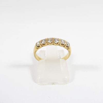 a yellow gold ring with five diamonds on a white background