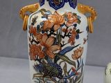 two vases sitting next to each other on a table