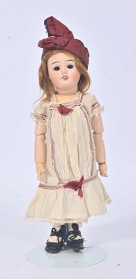 a doll that is wearing a dress and a hat