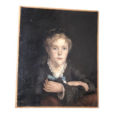 portrait of a young woman with a blue bow tie by a table