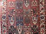 an antique persian rug with many different colors and patterns