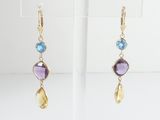 a pair of gold earrings with amethorate and blue topazte