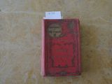 un petit livre rouge posé sur une table