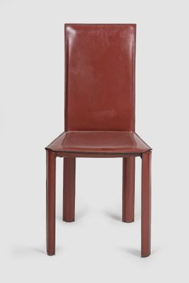 the back of a red leather chair with a wooden frame