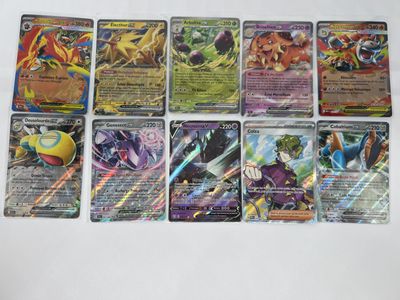 several pokemon cards are lined up on a white surface
